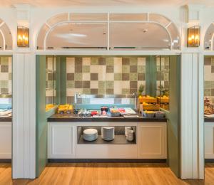 a kitchen with a counter with food on it at Catalonia Donosti in Donostia-San Sebastián