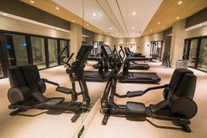 a row of treadmills and ellipticals in a gym at Catalonia Donosti in Donostia-San Sebastián