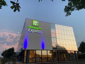 a building with a sign on the side of it at Holiday Inn Express - Arcachon - La Teste, an IHG Hotel in La Teste-de-Buch
