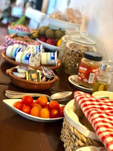 a table topped with plates of food and bowls of fruit at Surfescape Fuerteventura in Lajares