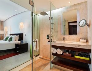 a bathroom with a large mirror and a large tub at The Park Chennai in Chennai