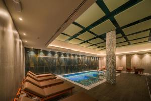 a swimming pool in the middle of a room at Catalonia Donosti in Donostia-San Sebastián