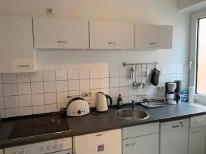 a kitchen with a sink and a counter top at City Studio Apartment in Bremerhaven