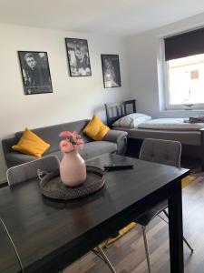 a living room with a couch and a table at City Studio Apartment in Bremerhaven