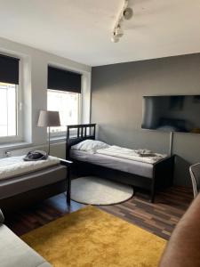 a bedroom with two beds and a tv at City Studio Apartment in Bremerhaven