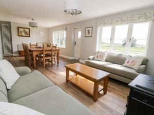 a living room with a couch and a table at West Farm in Great Yarmouth