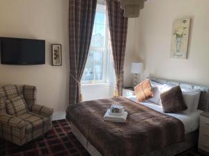 a hotel room with two beds and a window at Haughton Arms Hotel in Alford