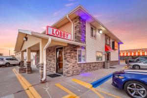 a hotel with a sign in a parking lot at Econo Lodge Hays I-70 in Hays