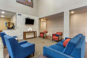 a living room with a blue couch and chairs at Comfort Suites Cordova in Memphis