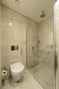 a bathroom with a toilet and a glass shower at Holiday Inn Bursa - City Centre by IHG in Bursa