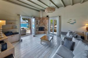 a living room with a couch and a fireplace at Marconi's seaside villa in Megas Gialos - Nites