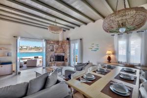 a living room with a table and a couch at Marconi's seaside villa in Megas Gialos - Nites