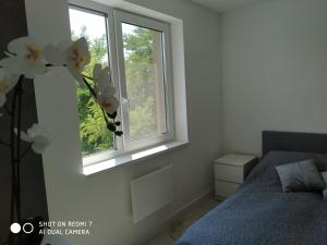 Posteľ alebo postele v izbe v ubytovaní Panoráma Apartman Tiszafüred