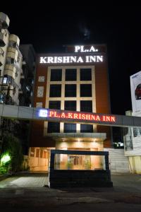 a building with a sign on the front of it at PLA Krishna Inn in Tiruchchirāppalli