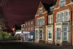 a building on a city street at night at voco St. Johns Solihull, an IHG Hotel in Solihull