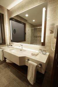 a bathroom with a sink and a large mirror at Holiday Inn Bursa - City Centre by IHG in Bursa