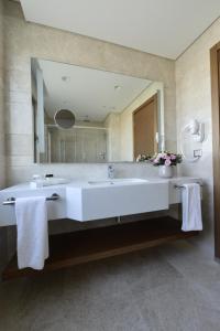 a bathroom with a large tub and a large mirror at Holiday Inn Bursa - City Centre by IHG in Bursa
