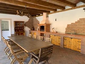 a large dining room with a wooden table and chairs at Moradia Pinhal da Telha in Corroios