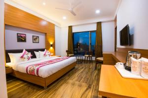 a hotel room with a bed and a desk at Hotel Sheetal in Jodhpur