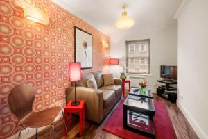 a living room with a couch and a table at Marylebone - Chiltern Street by Viridian Apartments in London