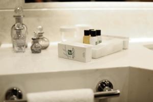 a bathroom counter with a sink with products on it at Holiday Inn Bursa - City Centre by IHG in Bursa
