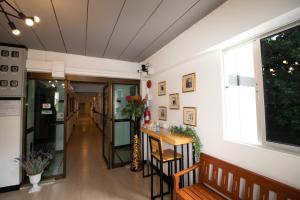 a hallway of a building with a table and a window at The 168 Gallery Residence and Hotel in Chiang Mai