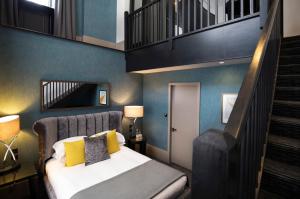 a bedroom with a bed and a stair case at Malmaison Oxford in Oxford
