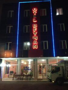 a hotel with a neon sign on the side of it at Hotel Beyhan in Mersin