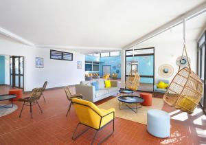 a living room with chairs and a couch at Résidence Néméa Les Carrats - Port Leucate in Port Leucate