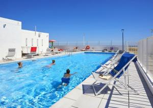 a group of people in a swimming pool at Résidence Néméa Les Carrats - Port Leucate in Port Leucate