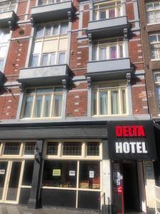a building with a hotel sign in front of it at Delta Hotel City Center in Amsterdam