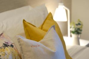 a bed with pillows and pillows on top of it at Stay in Apartments Ribeira 24 in Porto