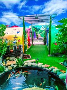 a garden with a koi pond in the yard at NHÀ NGHỈ K house in Ben Tre