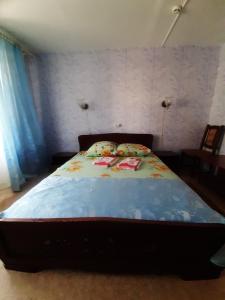 ブリャンスクにあるGostinitsa Turistのベッドルーム1室(青い掛け布団付きのベッド1台付)