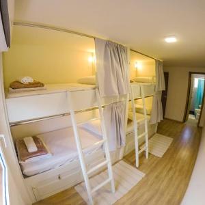 a room with four bunk beds in it at Hostel Central São Sebastião in São Sebastião