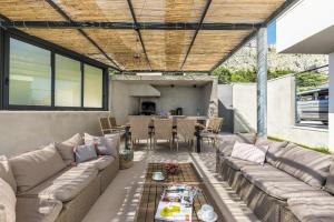 a living room with couches and a table with a table at Villa Lipa in Jesenice