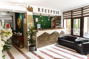 a lobby with a leather couch in a store at Piscul Negru Hotel - Transfagarasan in Cumpăna