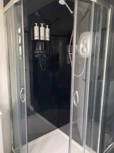 a shower with a glass door in a bathroom at Dallaire House in Banchory