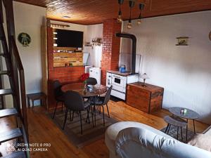 a kitchen and dining room with a table and chairs at Konak Pahulja TARA in Bajina Bašta