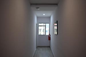 an empty hallway with a door and a window at Sunrise Hotel in Petaling Jaya