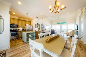 a kitchen with a table and chairs and a dining room at License to Chill in Dauphin Island