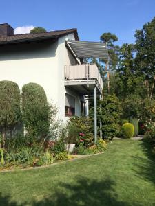 a house with a balcony and a lawn at Super XXL Ferienwohnung 73 qm, mit Balkon in Cadolzburg