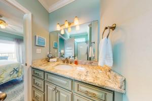 a bathroom with a sink and a large mirror at License to Chill in Dauphin Island +42 photos