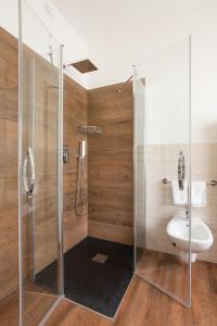 a bathroom with a shower with a toilet and a sink at Jägerhaus in Pellizzano