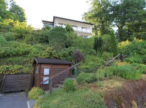a small house on a hill with a garden at Rothaarsteig Ferienhaus in Kirchhundem