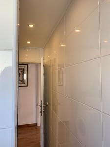 a bathroom with a shower with a glass wall at Privatzimmervermietung in Salzburg