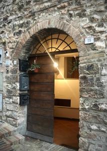 a door to a building with a stone wall at Belvedere Spello in Spello +13 photos