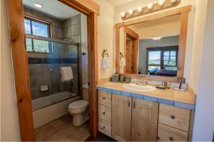 a bathroom with a toilet and a sink and a mirror at Town Point Condos by Lespri Property Management in Park City