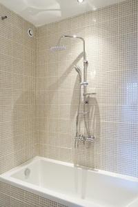 a bathroom with a shower and a bath tub at VILLA EPERONNIERE in Nantes +49 photos