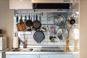 a kitchen with pots and pans hanging on the wall at SORAPIA Villa Mt.FUJI Front in Fujikawaguchiko